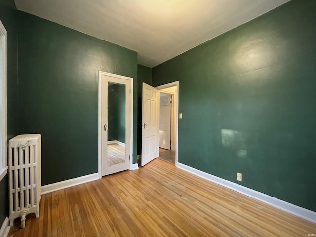 5425 Lincoln Ave, Evansville, IN 47715 - unfurnished room with wood finished floors, radiator heating unit, and baseboards