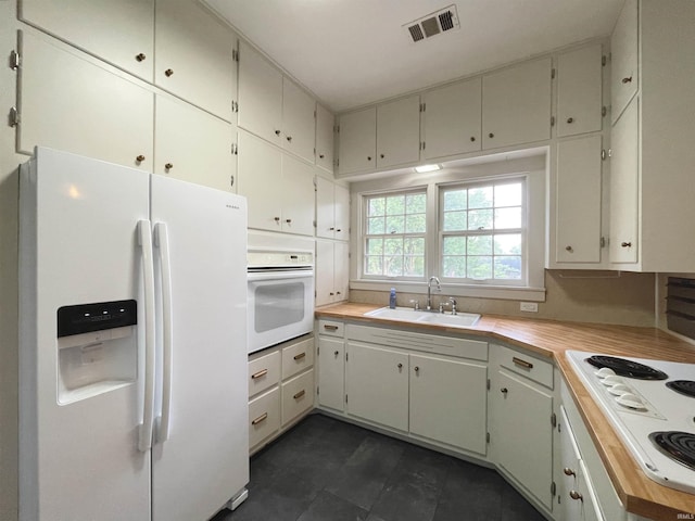 5425 Lincoln Ave, Evansville, IN 47715 - kitchen featuring white appliances, a sink, light countertops, and dark tile patterned floors