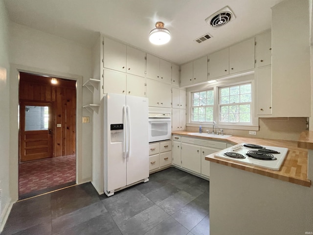5425 Lincoln Ave, Evansville, IN 47715 - kitchen featuring white appliances, a sink, light countertops, white cabinets, and a peninsula
