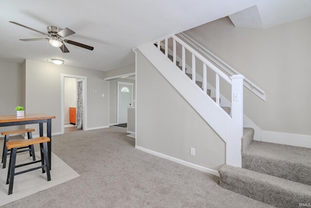 8694 W 1000 S Unit 35, Lafontaine, IN 46940 - unfurnished dining area featuring stairs, carpet, ceiling fan, and baseboards