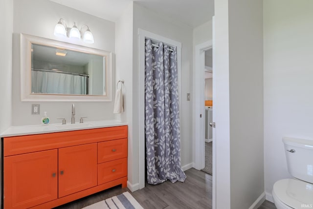 8694 W 1000 S Unit 35, Lafontaine, IN 46940 - bathroom featuring wood finished floors, vanity, toilet, and baseboards