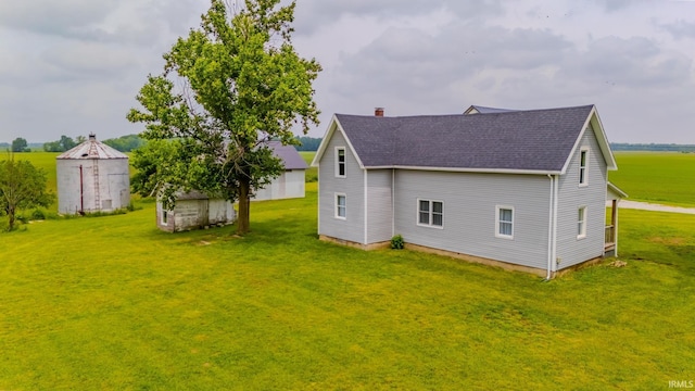 8694 W 1000 S Unit 35, Lafontaine, IN 46940 - view of home's exterior featuring a shingled roof, a chimney, and a lawn