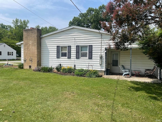 404 Klinger Ave, Plymouth, IN 46563 - back of house featuring a lawn