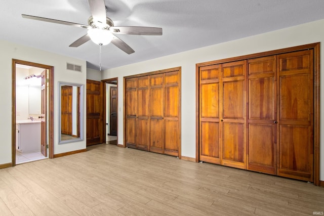 2299 Brown Chapel Rd, Boonville, IN 47601 - unfurnished bedroom with light wood-style flooring, two closets, baseboards, and ensuite bathroom