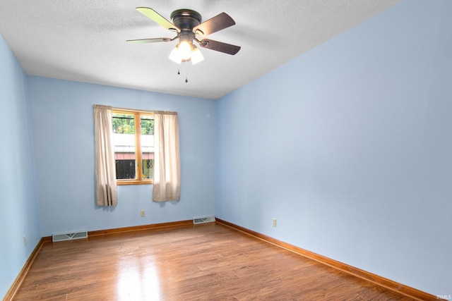 2299 Brown Chapel Rd, Boonville, IN 47601 - empty room with wood finished floors, ceiling fan, baseboards, and a textured ceiling