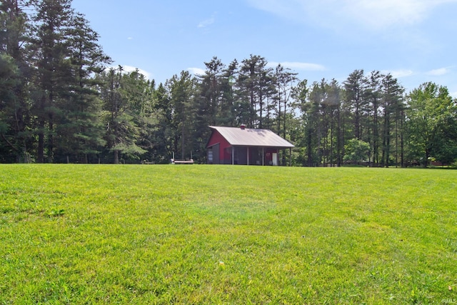 2299 Brown Chapel Rd, Boonville, IN 47601 - view of green lawn featuring a pole building, a garage, and an outbuilding