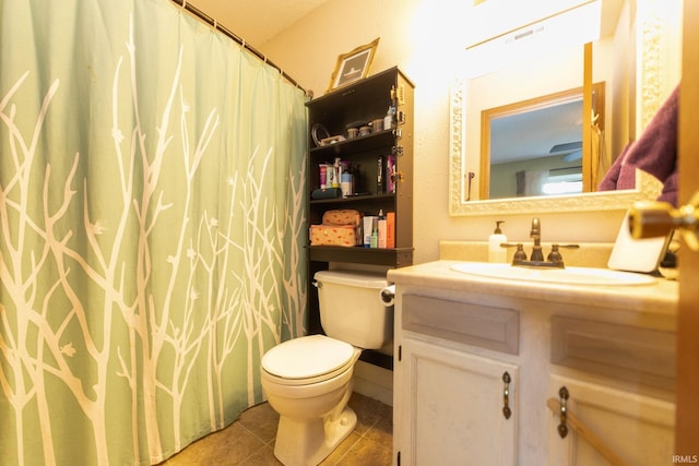 5530 W Cobblestone St, Bloomington, IN 47403 - bathroom featuring toilet, vanity, tile patterned flooring, and a shower with curtain