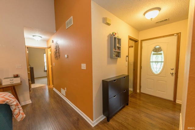 5530 W Cobblestone St, Bloomington, IN 47403 - foyer entrance with dark wood finished floors, a textured ceiling, and baseboards