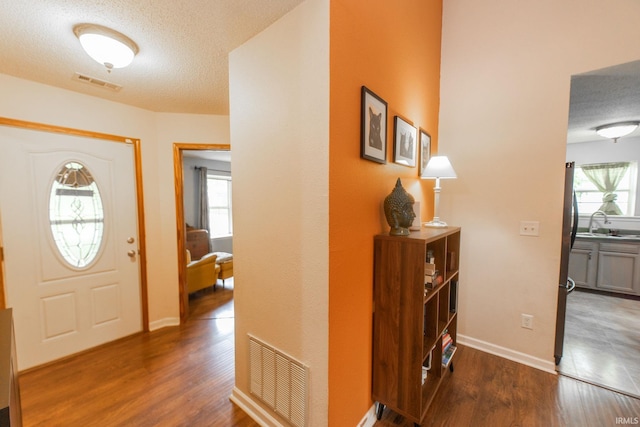 5530 W Cobblestone St, Bloomington, IN 47403 - entrance foyer featuring wood finished floors, a textured ceiling, and baseboards