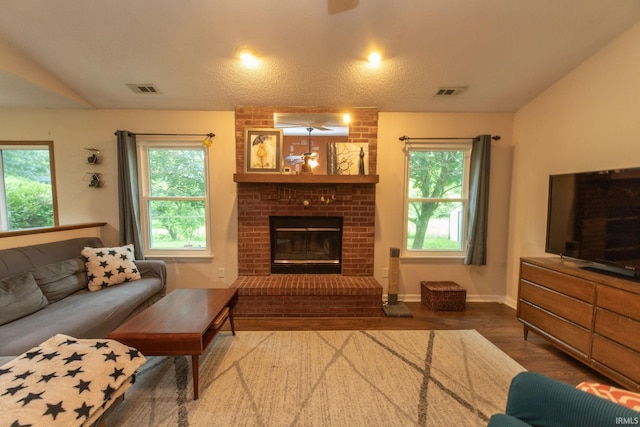 5530 W Cobblestone St, Bloomington, IN 47403 - living area with wood finished floors, a fireplace, a ceiling fan, baseboards, and lofted ceiling