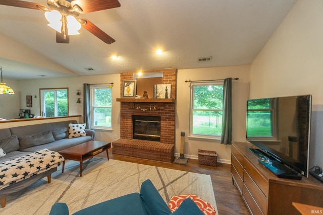 5530 W Cobblestone St, Bloomington, IN 47403 - living room with wood finished floors, plenty of natural light, a brick fireplace, lofted ceiling, and a ceiling fan