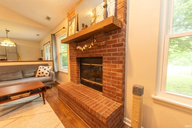 5530 W Cobblestone St, Bloomington, IN 47403 - living area with lofted ceiling, wood finished floors, healthy amount of natural light, and a fireplace