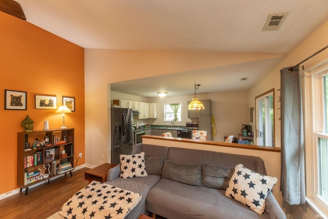 5530 W Cobblestone St, Bloomington, IN 47403 - living area with lofted ceiling, dark wood-style floors, and baseboards