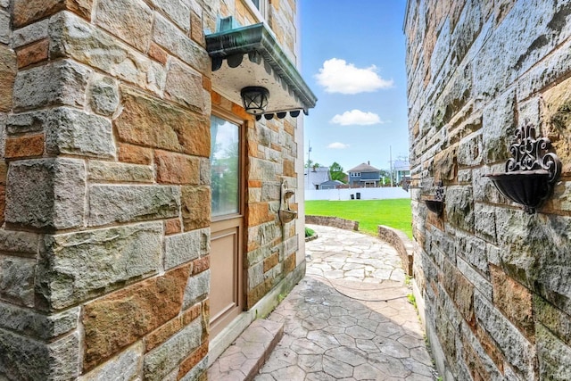 2307 Forest Park Blvd, Fort Wayne, IN 46805 - view of side of property featuring stone siding, a lawn, and a patio