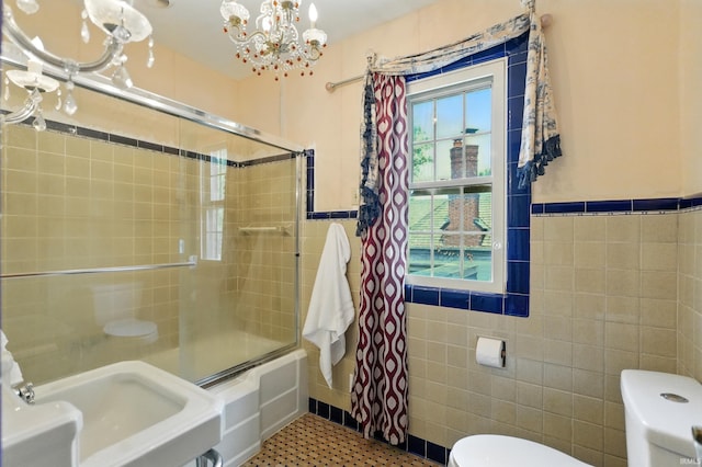 2307 Forest Park Blvd, Fort Wayne, IN 46805 - full bath with tile walls, enclosed tub / shower combo, a chandelier, tile patterned flooring, and wainscoting