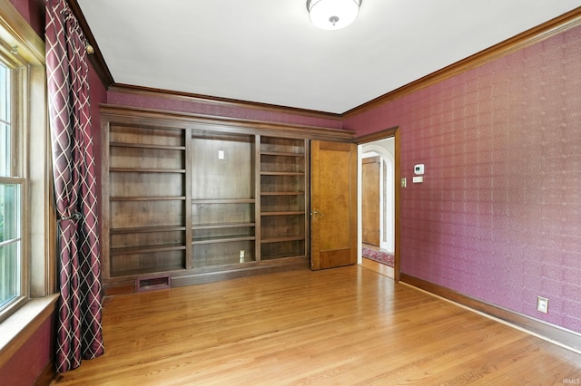 2307 Forest Park Blvd, Fort Wayne, IN 46805 - unfurnished room featuring arched walkways, ornamental molding, light wood-style flooring, and wallpapered walls