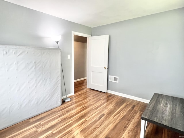 83 9th St, Logansport, IN 46947 - unfurnished bedroom featuring light wood-type flooring and baseboards