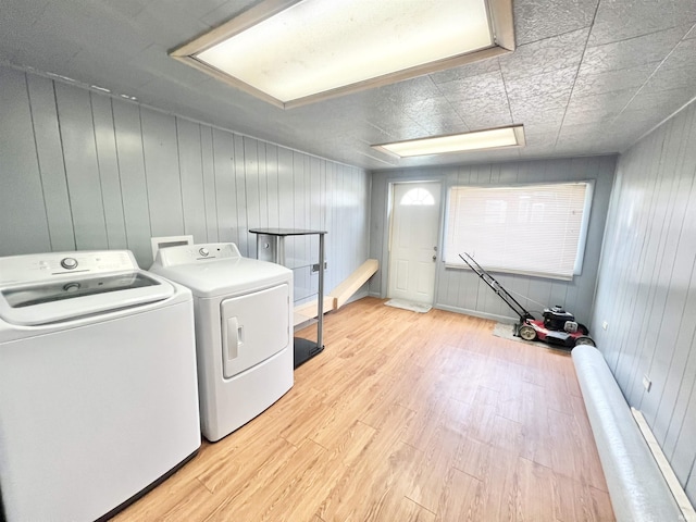 83 9th St, Logansport, IN 46947 - washroom featuring separate washer and dryer, light wood-style flooring, and wooden walls