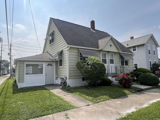 83 9th St, Logansport, IN 46947 - bungalow-style home with a chimney, a front lawn, and roof with shingles
