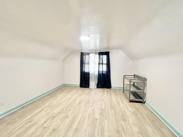 83 9th St, Logansport, IN 46947 - bonus room with wood finished floors, baseboards, and lofted ceiling