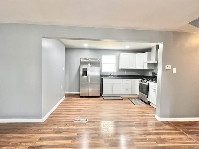 83 9th St, Logansport, IN 46947 - kitchen with appliances with stainless steel finishes, a sink, dark countertops, baseboards, and recessed lighting