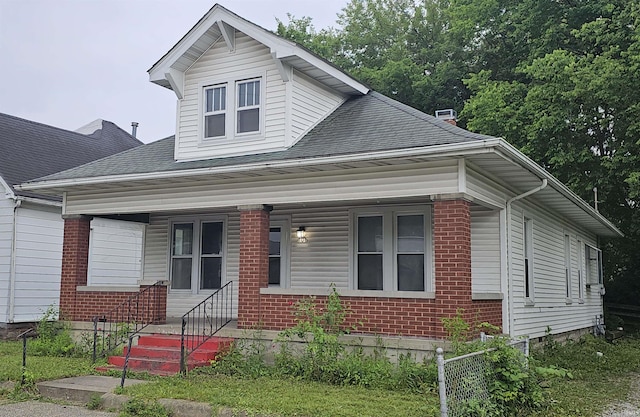106 N 21st St, Terre Haute, IN 47807 - view of front of property featuring brick siding, covered porch, and a shingled roof