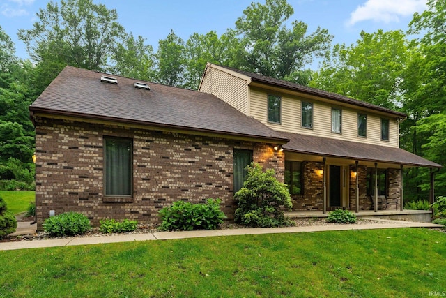 425 W 400 N, Columbia City, IN 46725 - view of front facade with a front lawn, covered porch, brick siding, and roof with shingles