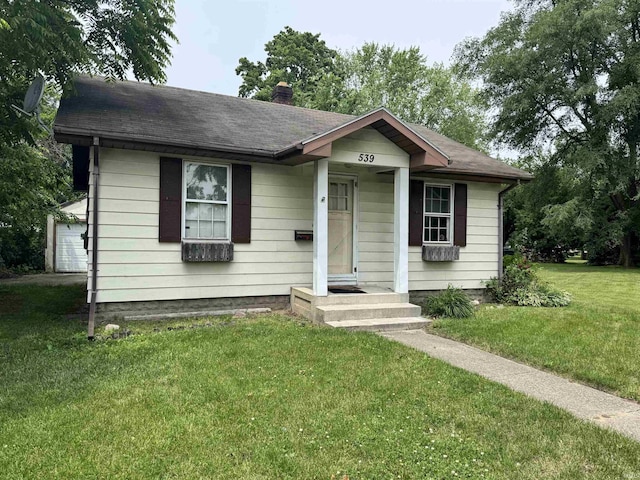 539 Goshen Ave, Elkhart, IN 46516 - bungalow-style house featuring a chimney, a front lawn, and roof with shingles