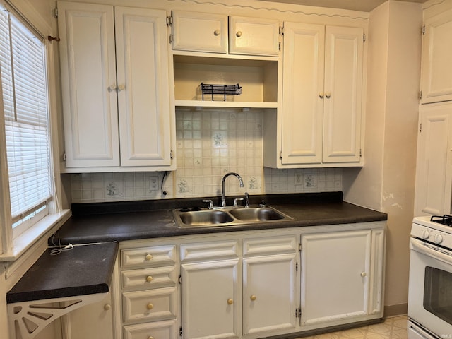 539 Goshen Ave, Elkhart, IN 46516 - kitchen with a sink, dark countertops, and white cabinets