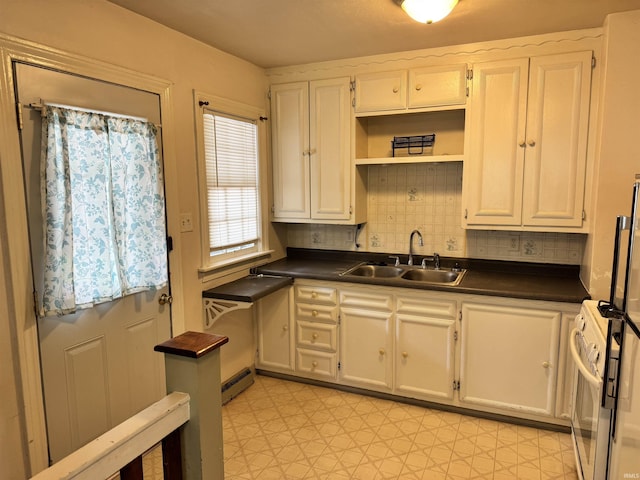 539 Goshen Ave, Elkhart, IN 46516 - kitchen featuring a sink, white range with gas cooktop, a baseboard heating unit, dark countertops, and decorative backsplash