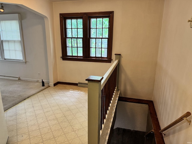 539 Goshen Ave, Elkhart, IN 46516 - stairway featuring a baseboard heating unit and baseboards