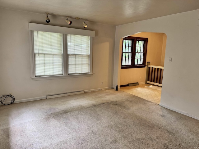 539 Goshen Ave, Elkhart, IN 46516 - carpeted spare room with baseboard heating, arched walkways, track lighting, and baseboards