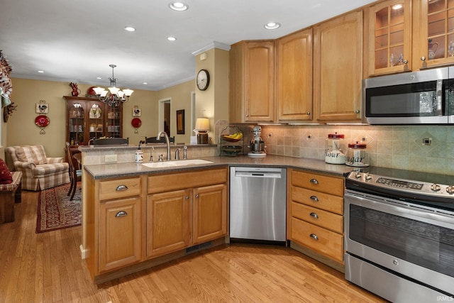 3709 Capilano Dr, West Lafayette, IN 47906 - kitchen with appliances with stainless steel finishes, a sink, ornamental molding, a peninsula, and a chandelier