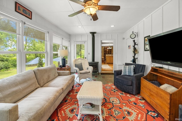 3709 Capilano Dr, West Lafayette, IN 47906 - living area featuring a wood stove, a ceiling fan, a decorative wall, and recessed lighting