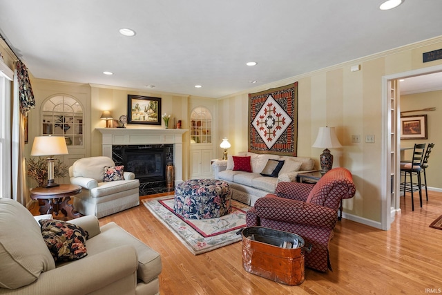 3709 Capilano Dr, West Lafayette, IN 47906 - living room with ornamental molding, wood finished floors, a high end fireplace, baseboards, and recessed lighting