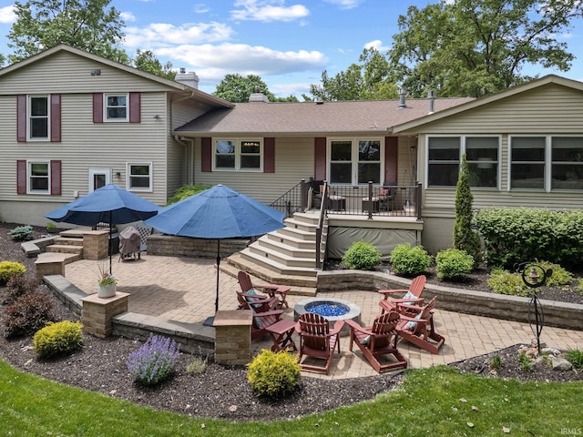 3709 Capilano Dr, West Lafayette, IN 47906 - back of property with a fire pit, a patio, a chimney, and stairs