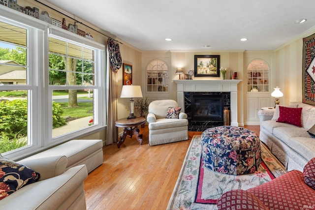 3709 Capilano Dr, West Lafayette, IN 47906 - living room with ornamental molding, a high end fireplace, light wood-type flooring, and recessed lighting