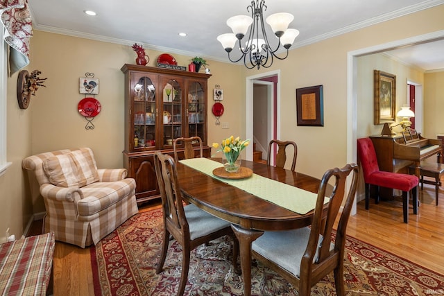 3709 Capilano Dr, West Lafayette, IN 47906 - dining area with wood finished floors, a chandelier, crown molding, and recessed lighting