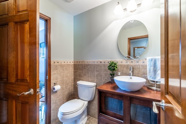 10909 Bittersweet Dells Ln, Fort Wayne, IN 46814 - bathroom with tile walls, vanity, a wainscoted wall, and toilet