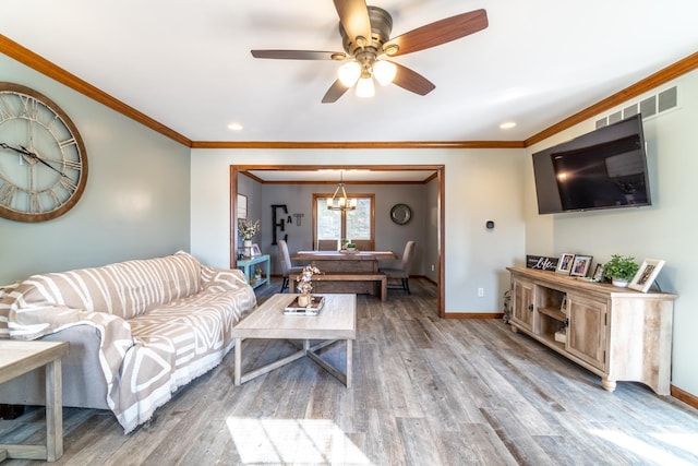 10909 Bittersweet Dells Ln, Fort Wayne, IN 46814 - living area featuring wood finished floors, a ceiling fan, baseboards, crown molding, and recessed lighting