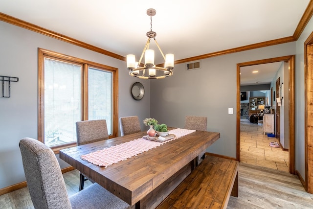 10909 Bittersweet Dells Ln, Fort Wayne, IN 46814 - dining space with a chandelier, crown molding, baseboards, and light wood-type flooring