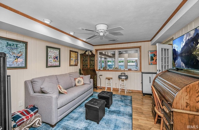 26051 Lake Dr, Elkhart, IN 46514 - living area featuring crown molding, wood finished floors, ceiling fan, and a textured ceiling