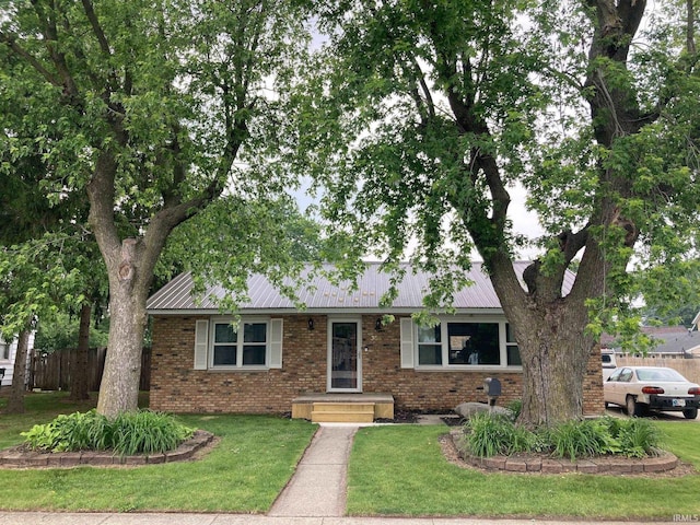 305 N Lincoln Ave, Fowler, IN 47944 - view of front of property with brick siding and metal roof
