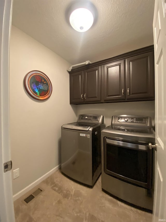 4310 E Duffy Dr, Syracuse, IN 46567 - laundry room with washer and dryer, cabinet space, and baseboards