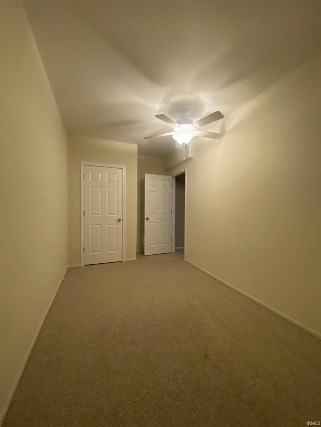 4310 E Duffy Dr, Syracuse, IN 46567 - unfurnished bedroom featuring carpet flooring, baseboards, and a ceiling fan