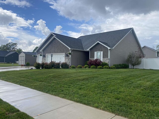 4310 E Duffy Dr, Syracuse, IN 46567 - view of front of house with stone siding, a garage, and a shingled roof
