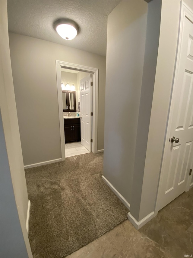 4310 E Duffy Dr, Syracuse, IN 46567 - hallway featuring light colored carpet, baseboards, and a textured ceiling