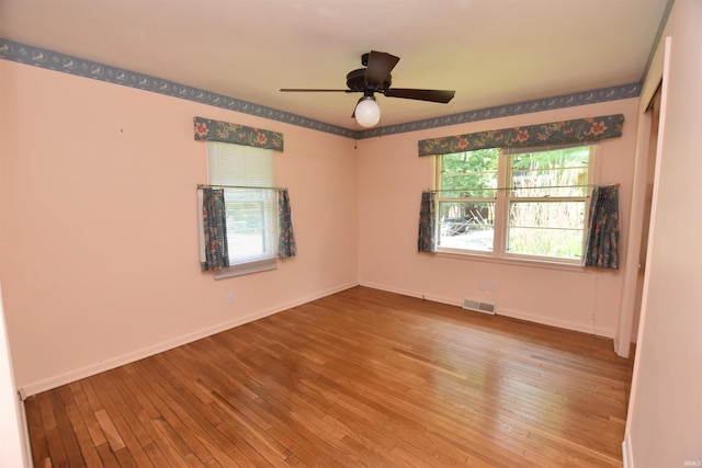 1200 S Longwood Dr, Bloomington, IN 47401 - spare room with hardwood / wood-style floors, ceiling fan, and baseboards