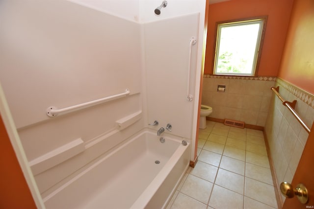 1200 S Longwood Dr, Bloomington, IN 47401 - full bathroom featuring toilet, tile walls, tile patterned floors, bathing tub / shower combination, and wainscoting