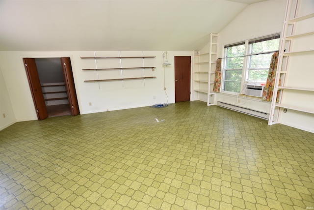 1200 S Longwood Dr, Bloomington, IN 47401 - unfurnished living room featuring baseboard heating, vaulted ceiling, and baseboards